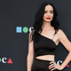 Krysten Ritter in a black dress.